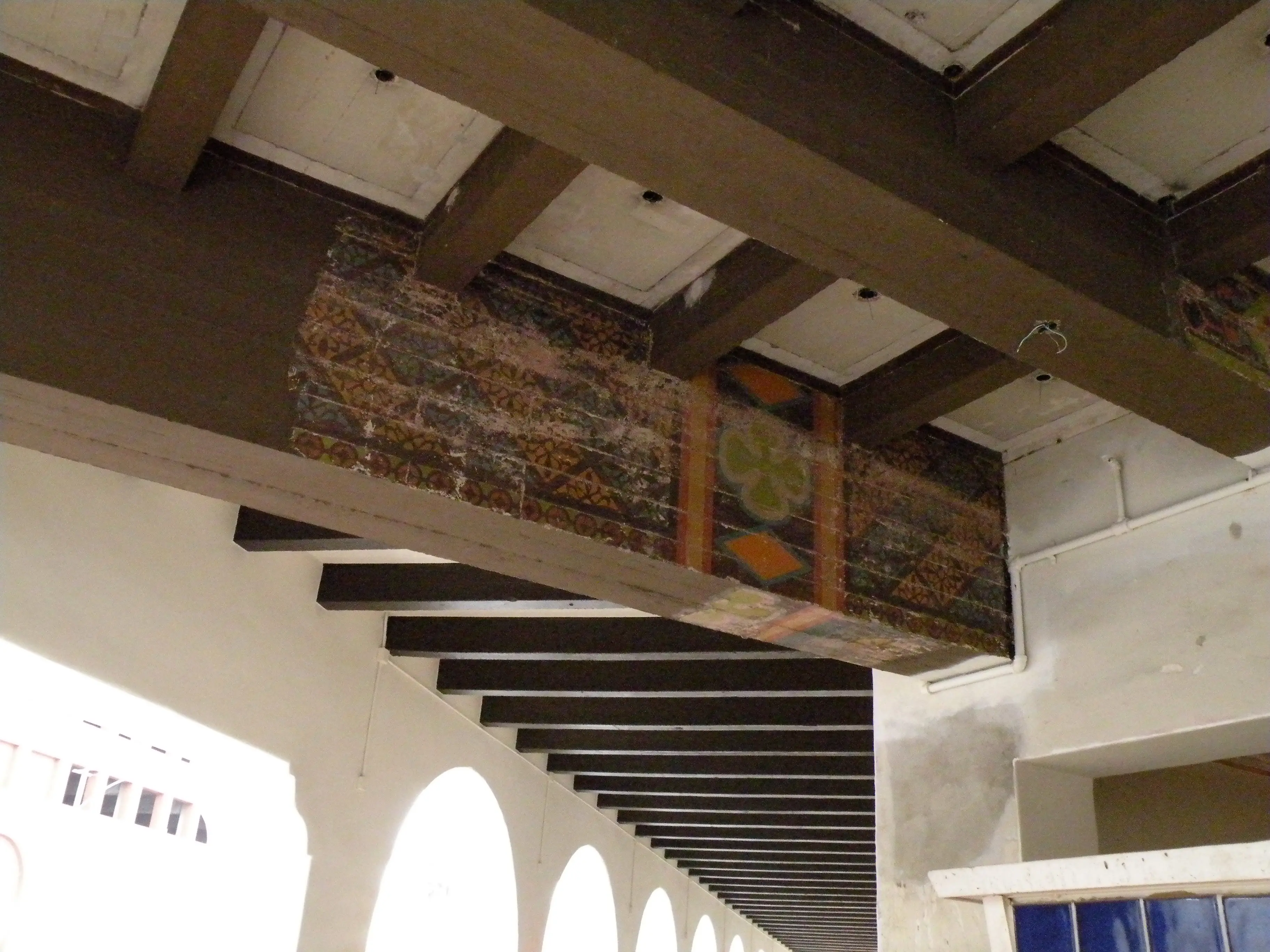 Original polychrome stencilling surviving on the coffered ceiling beams of the Fox Theatre Riverside before restoration