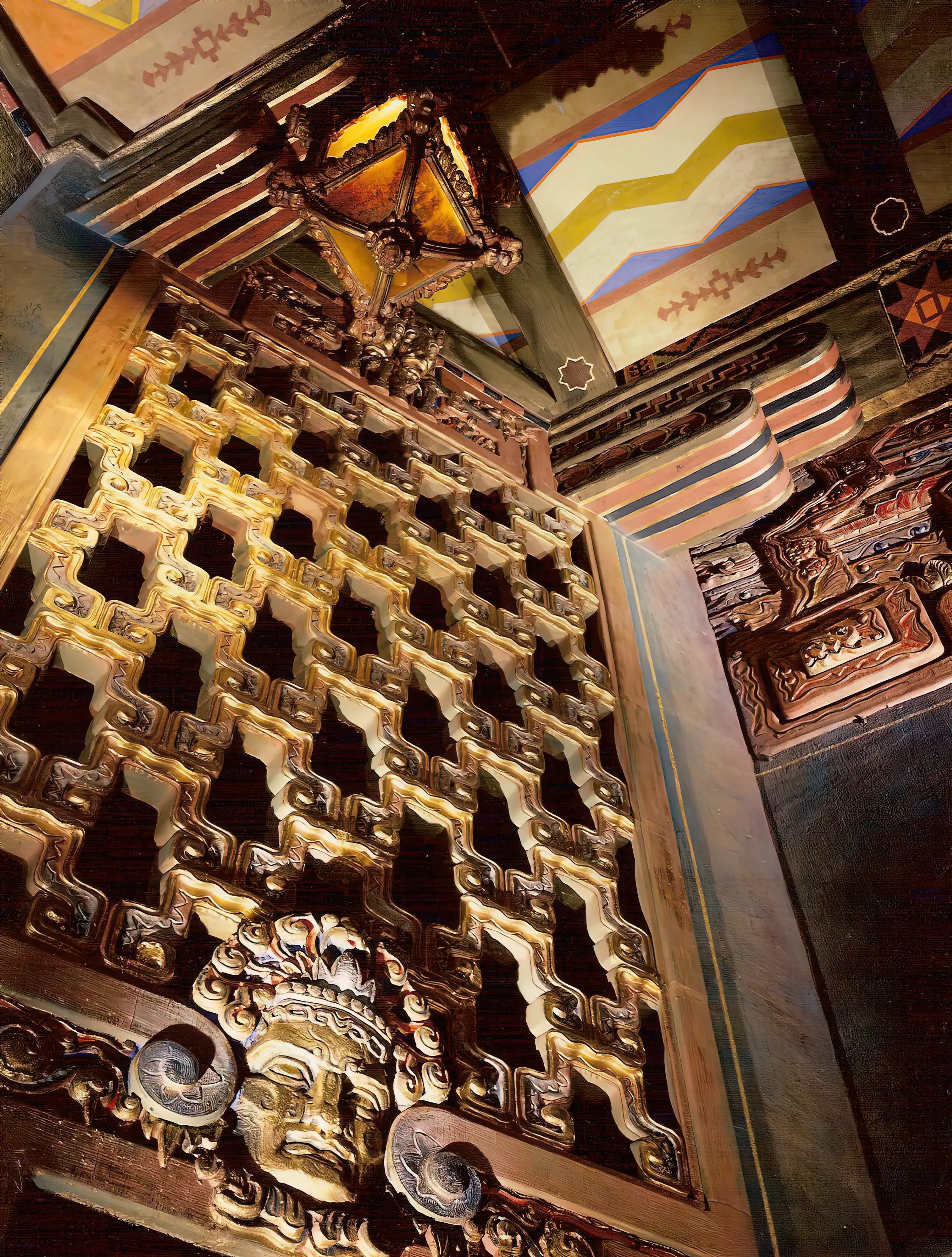 Restored gilded fretwork grille and polychrome carved ornament on a historic auditorium ceiling