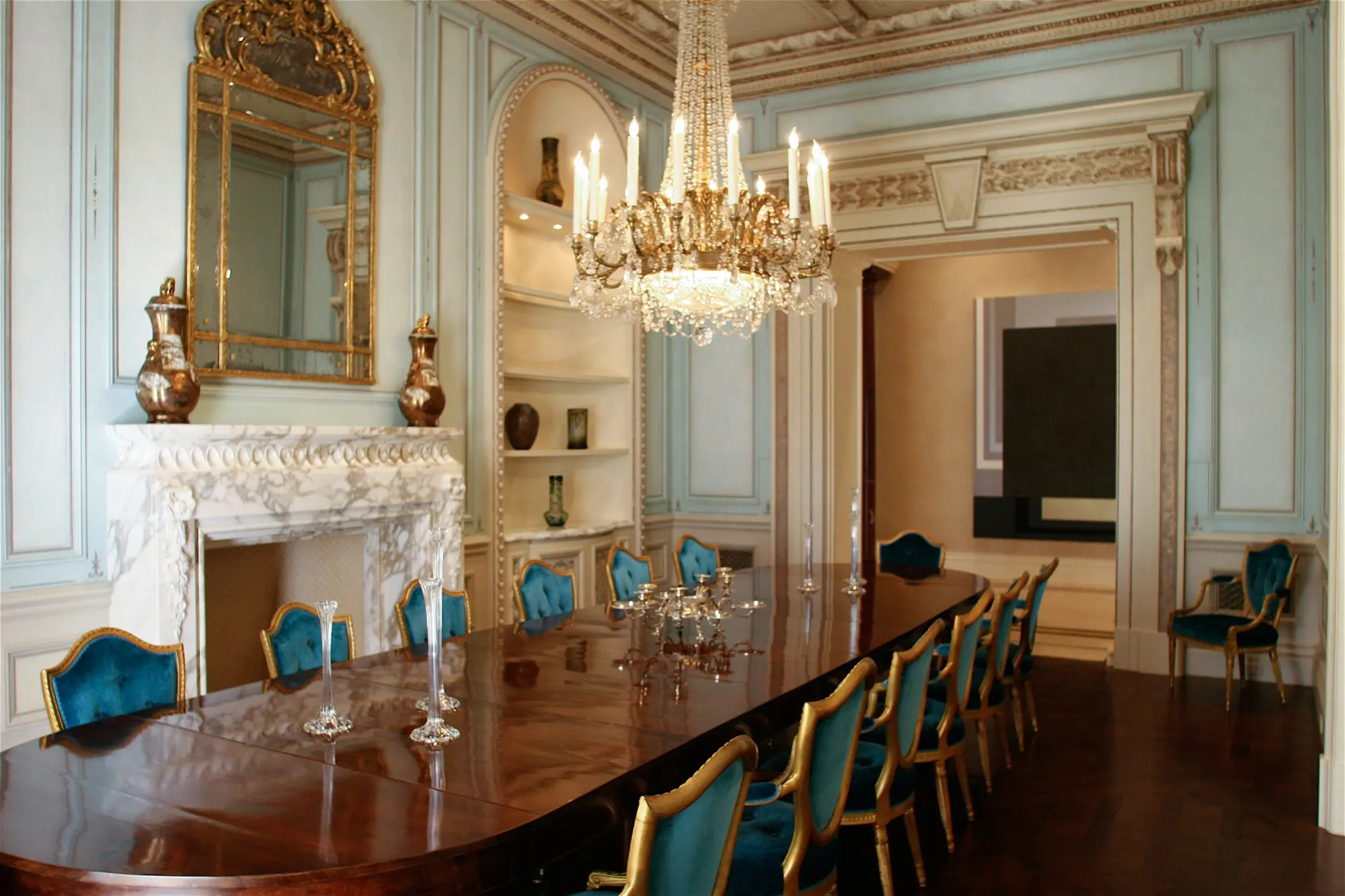 Reception room with glazed panelling, faux marble chimneypiece and gilded detail